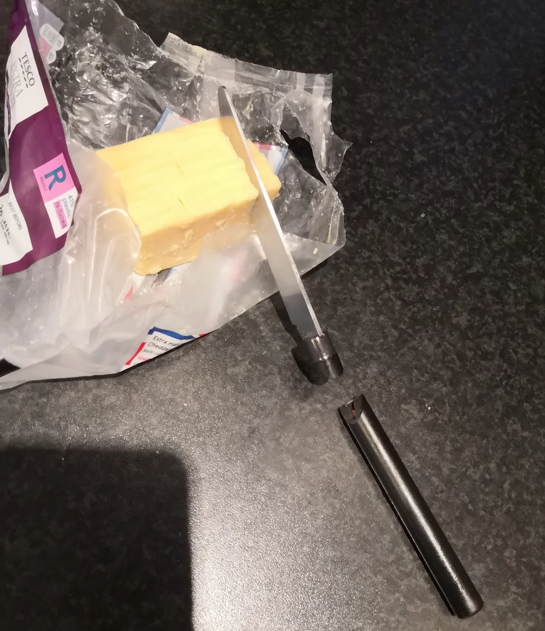 The cheese block with the broken knife embedded in it